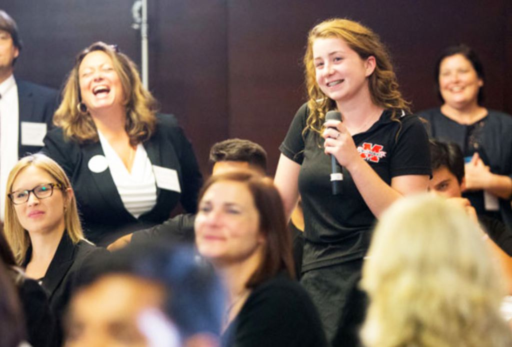 Student with microphone smiling